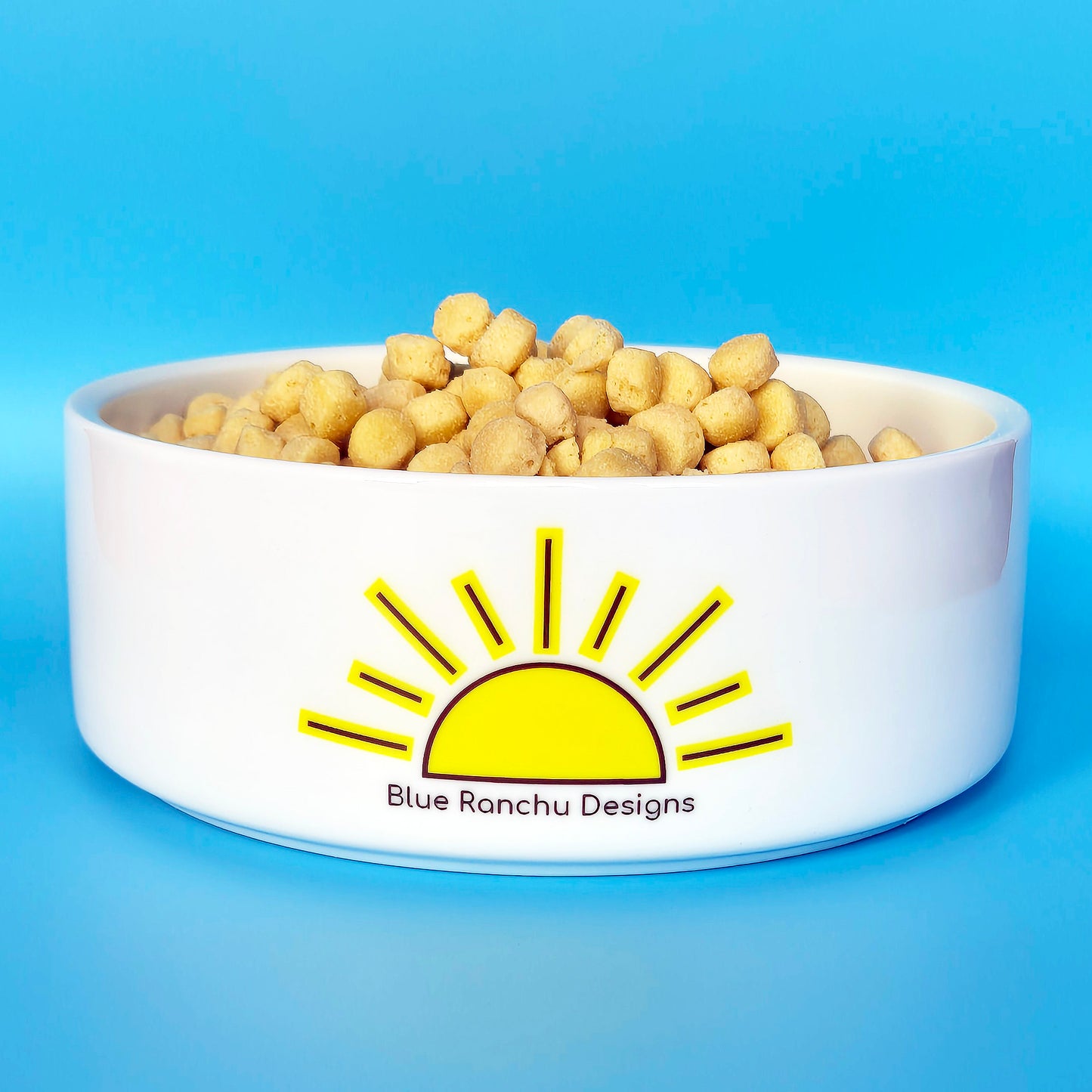 Back of ceramic pet bowl with sunrise design and logo
