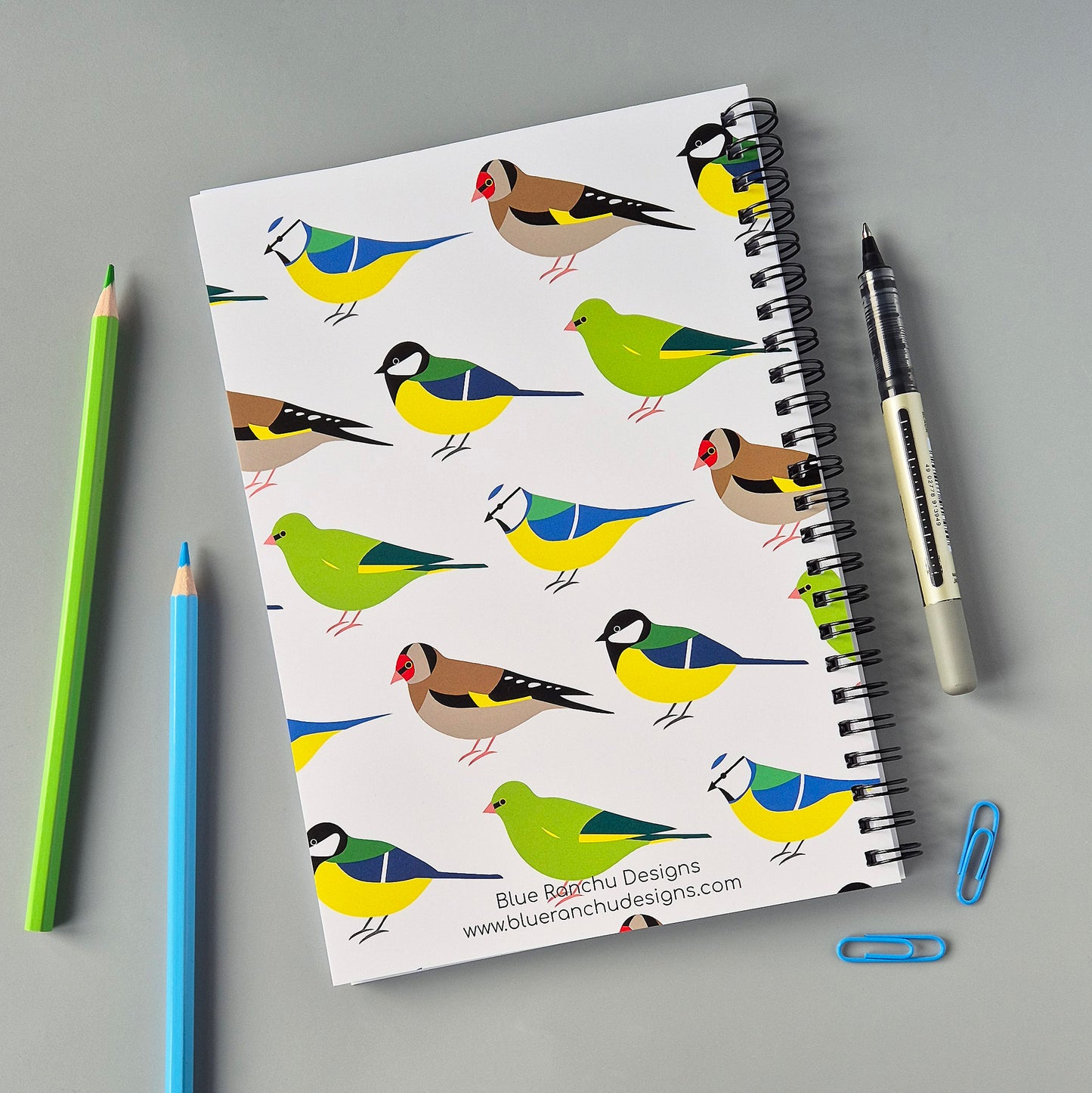 A5 wirebound notebook with colourful garden birds design on a white background