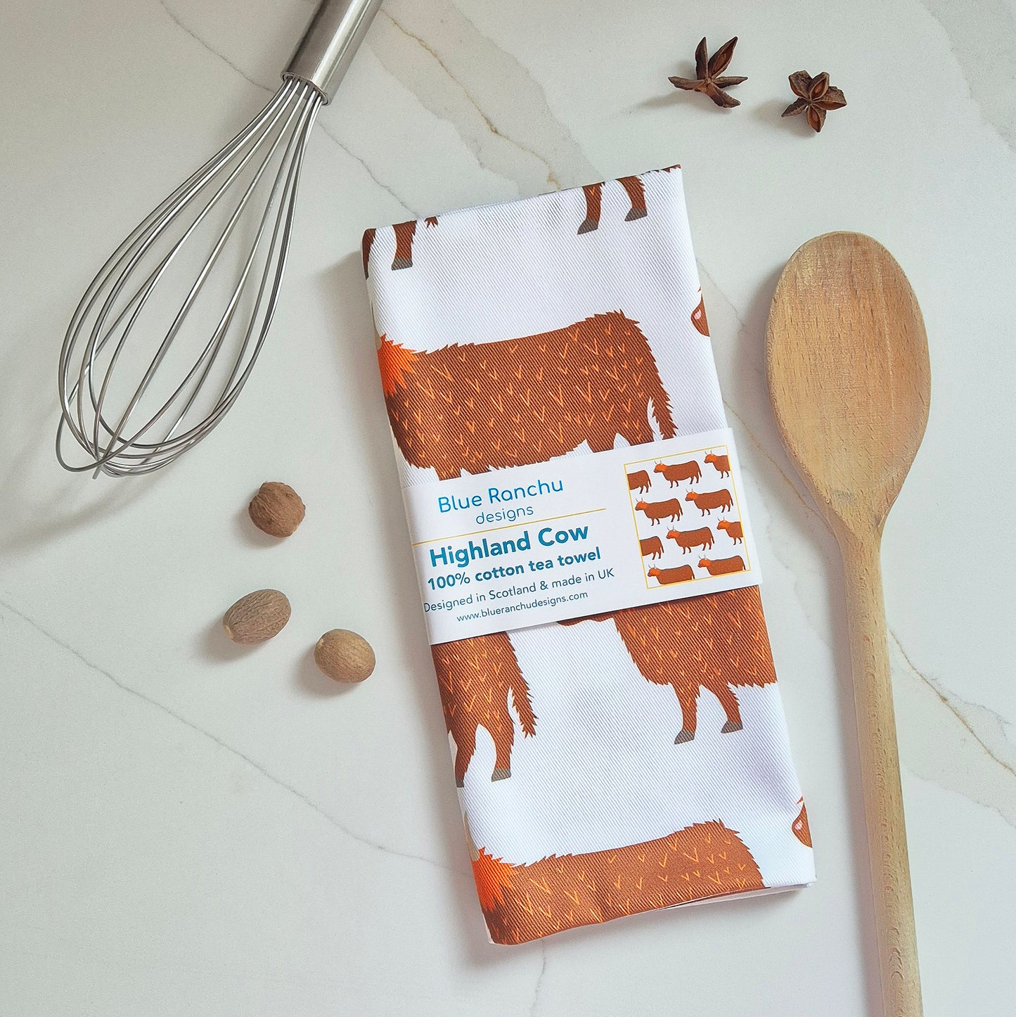Highland Cow tea towel folded on the worktop
