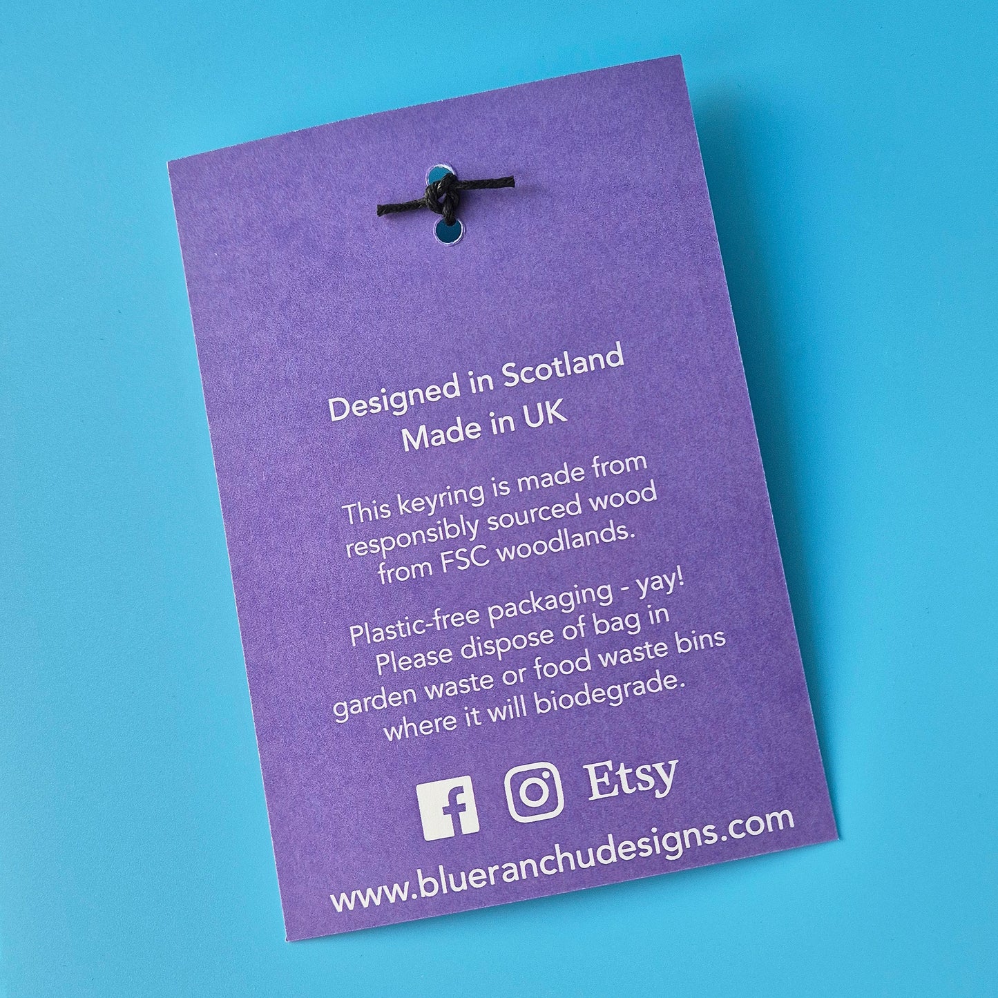 Purple keyring packaging with text on a blue background