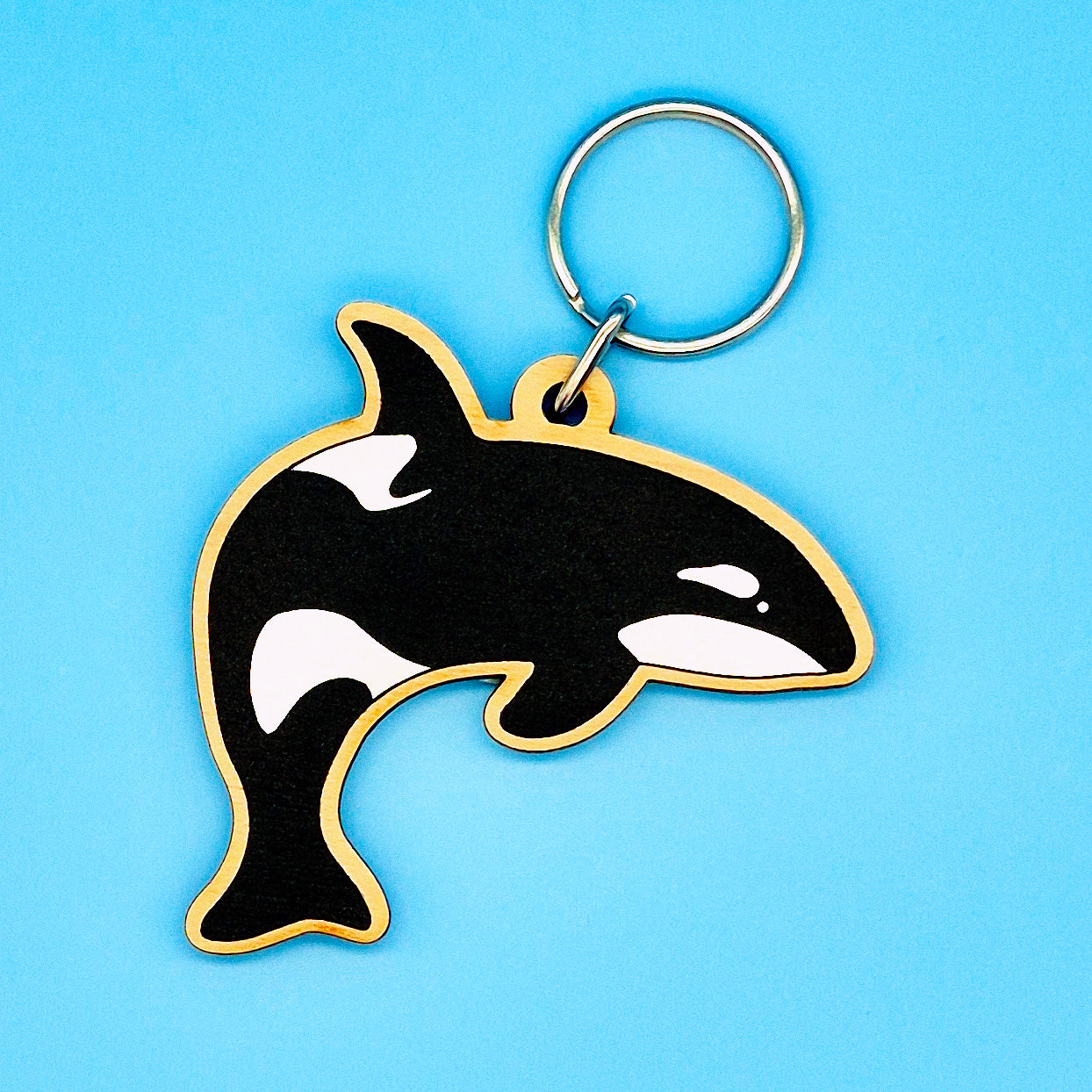 Orca whale keychain on a blue background