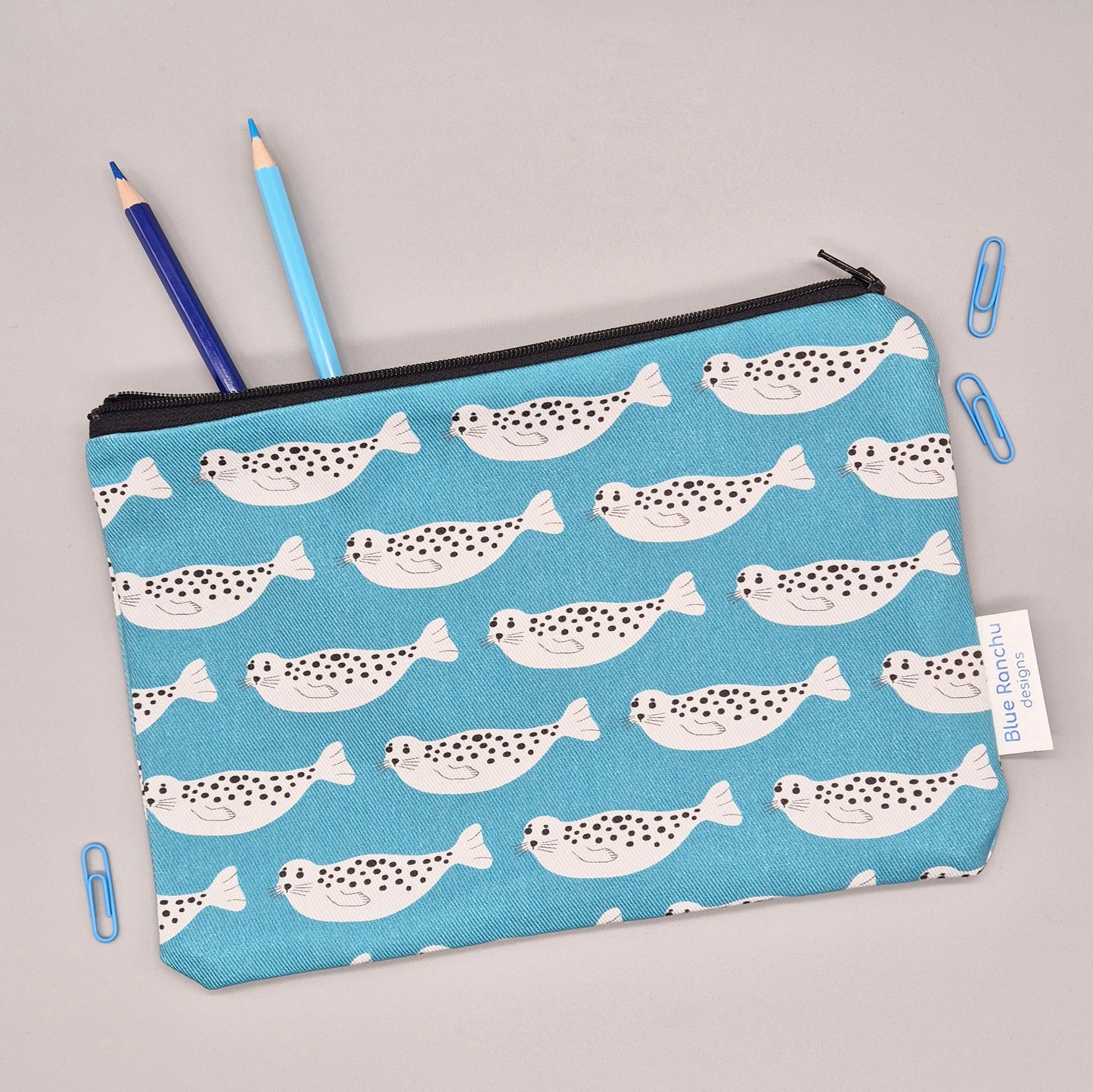 Grey Harbour Seal repeat pattern on a turquoise background handmade pencil case/accessories bag