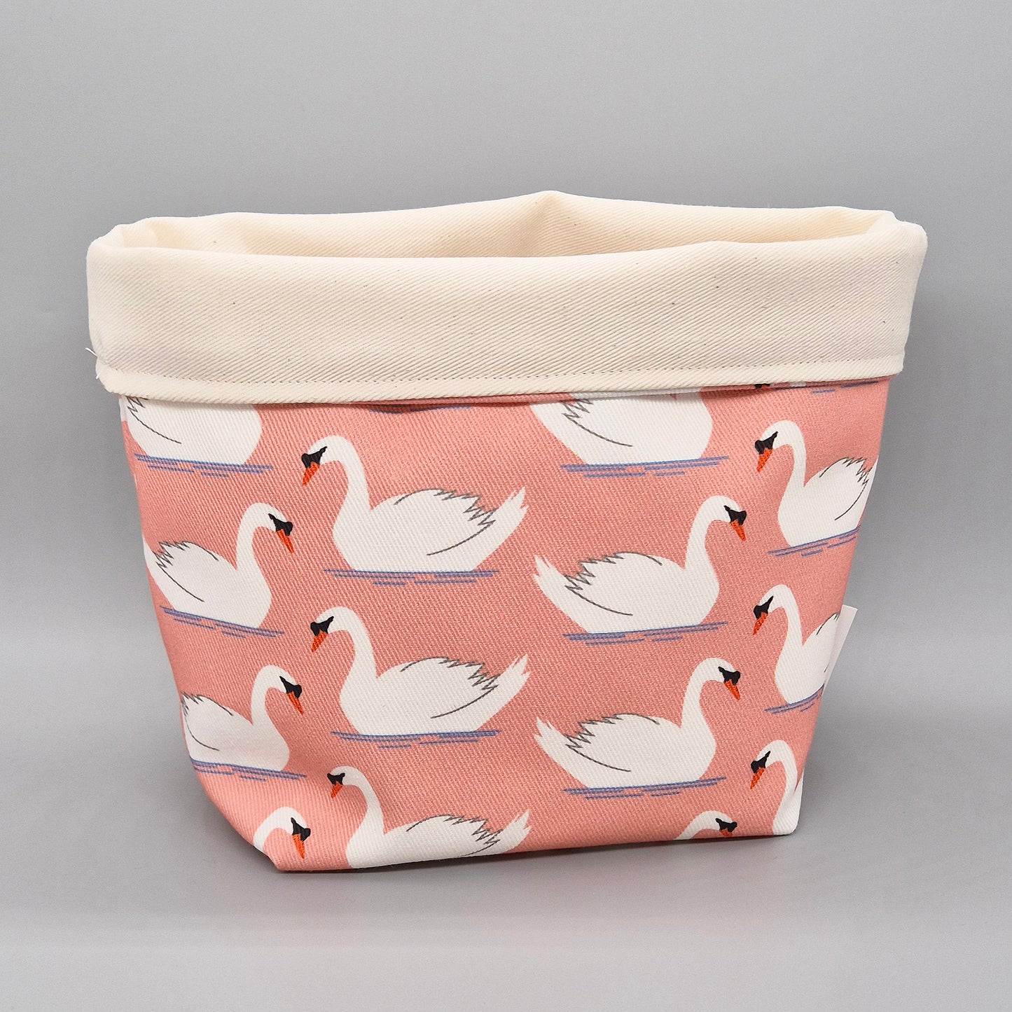 Swimming Swan with coral coloured background fabric storage basket