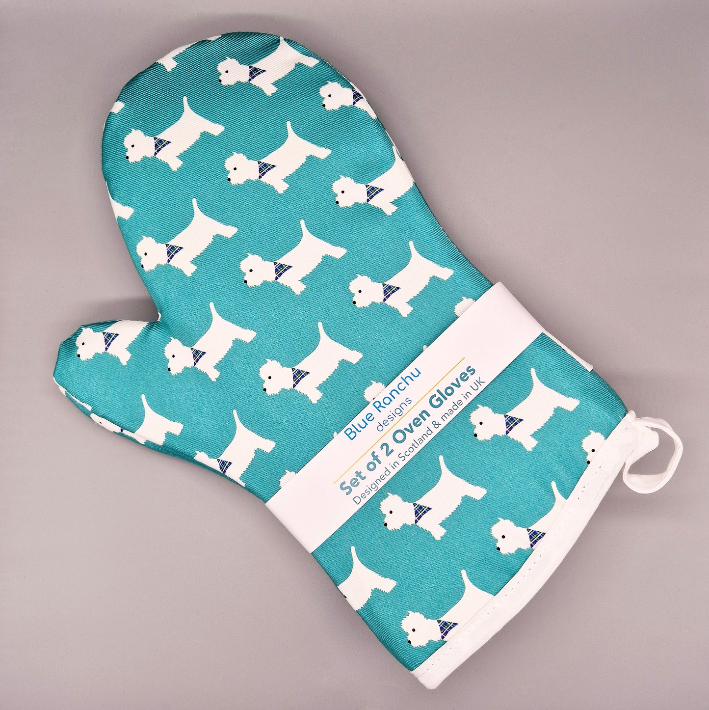 Set of 2 oven gloves with Westie dog pattern on a teal background