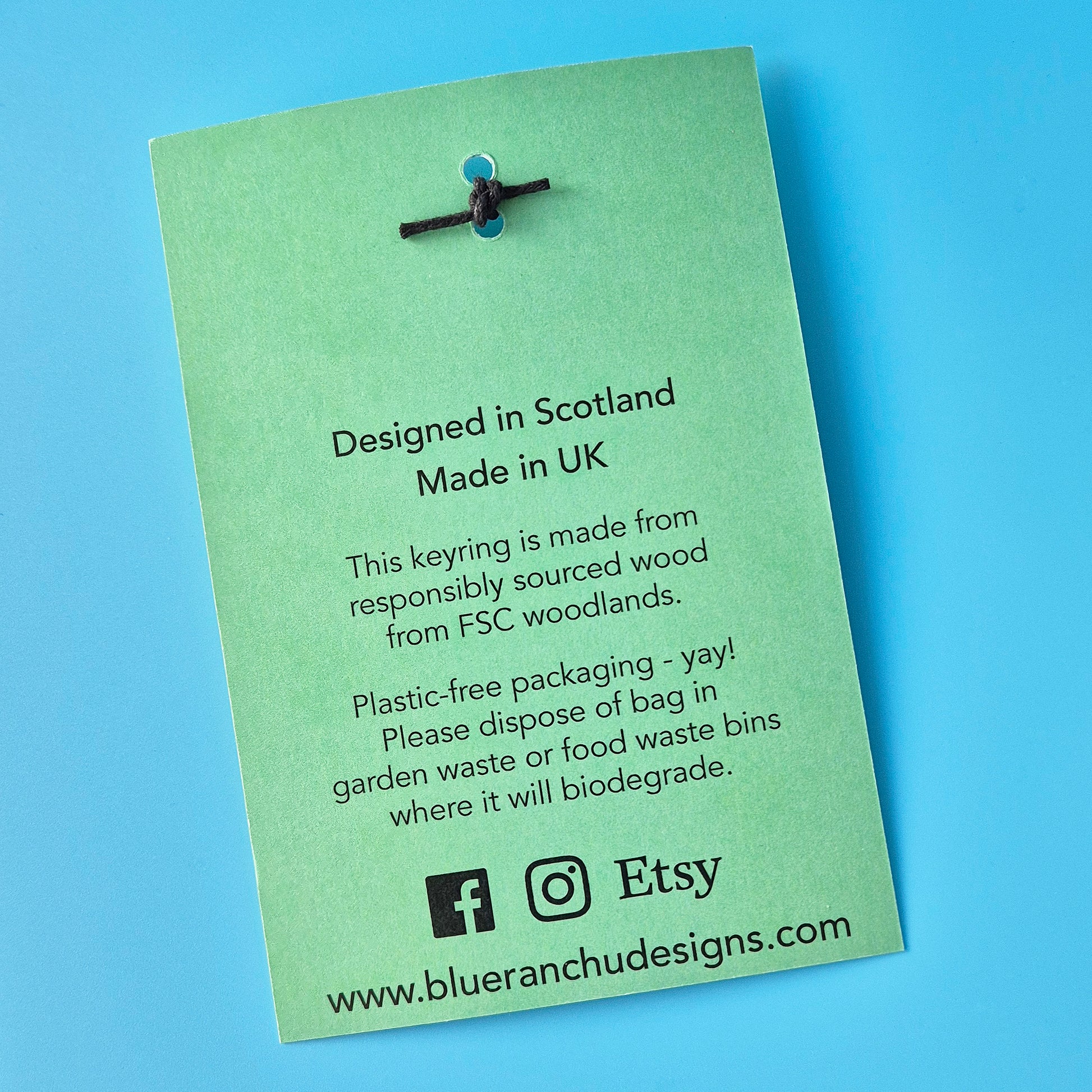 Backing card for keyring showing plastic-free packaging credentials