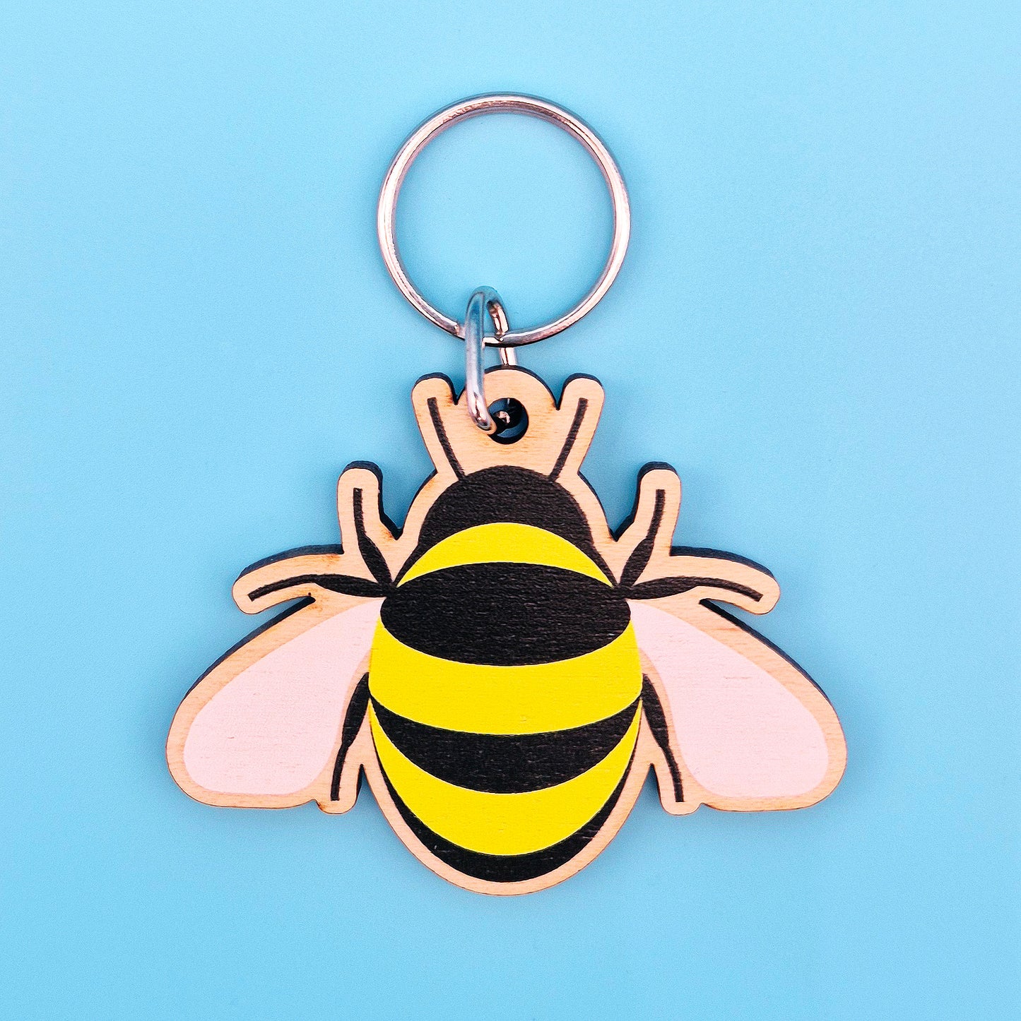 Bee-shaped keychain on a light blue background