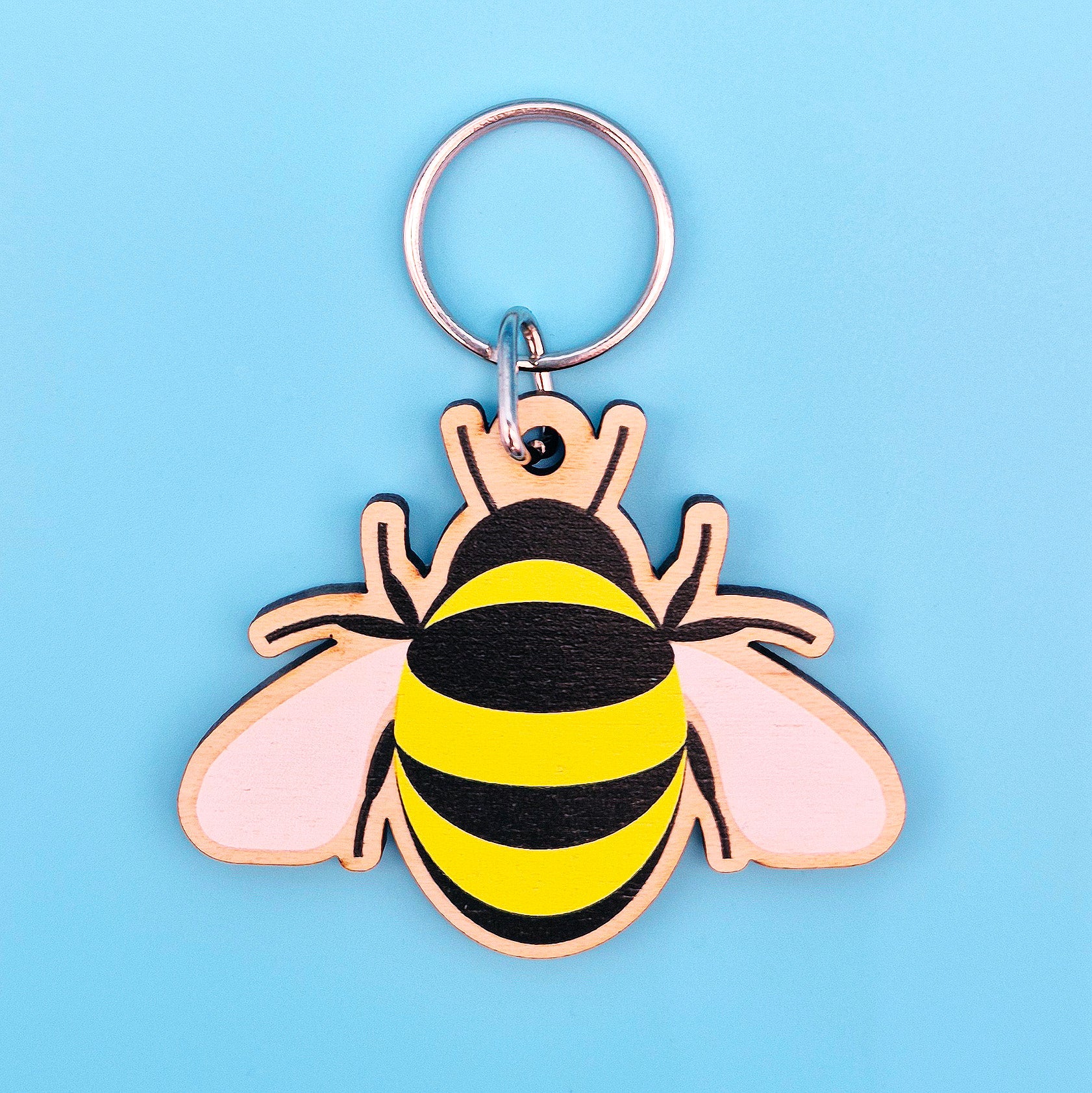 Bee-shaped keychain on a light blue background