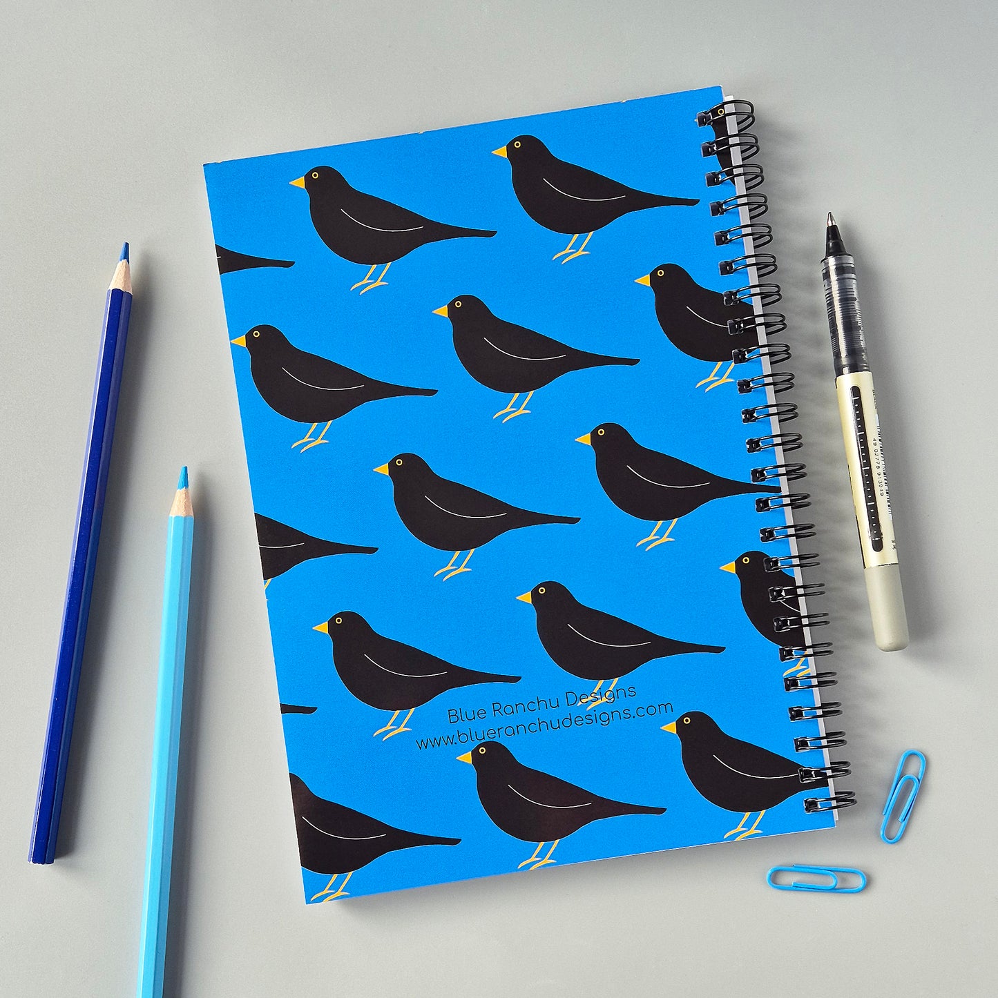 Blue A5 wirebound notebook with a blackbird pattern