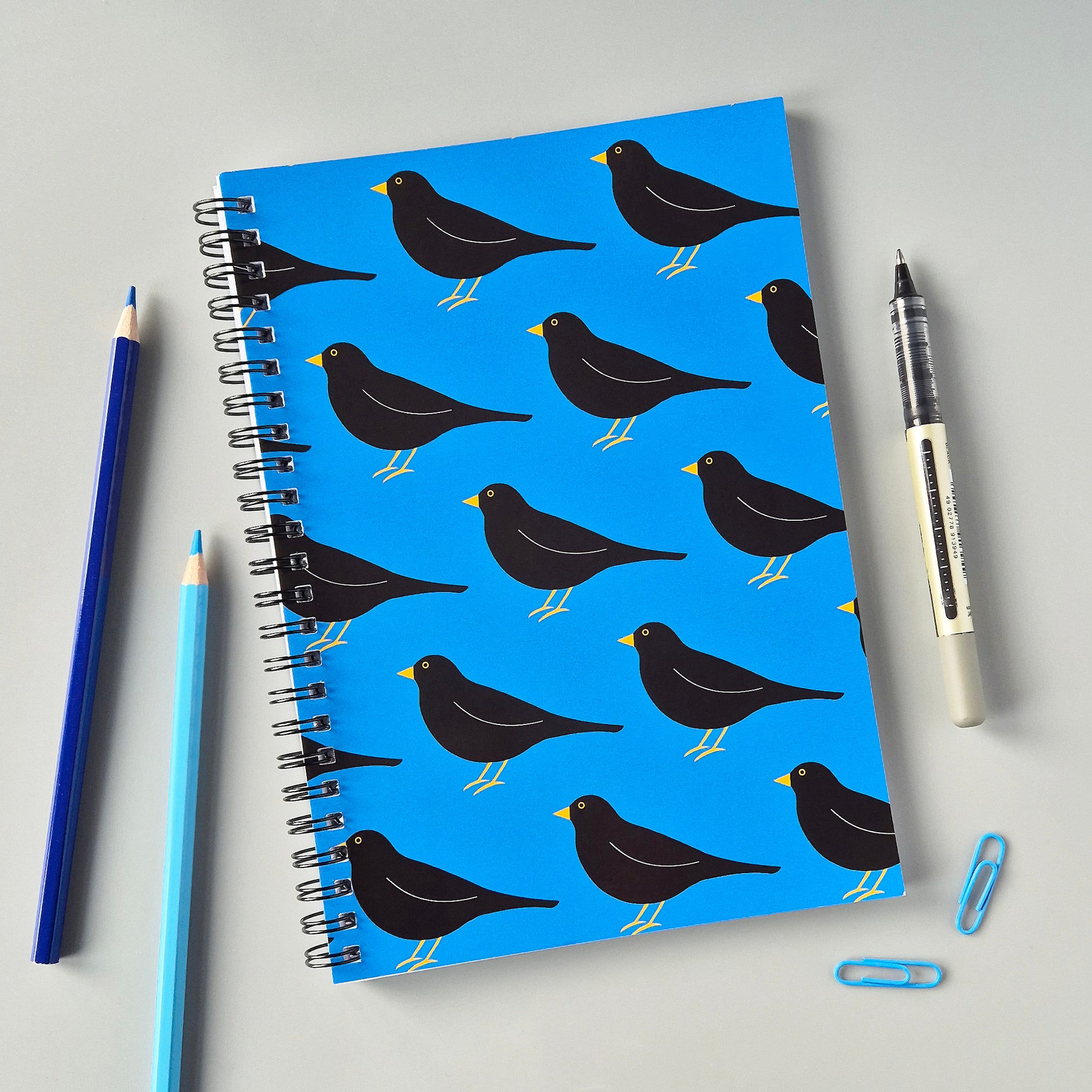 Blue A5 wirebound notebook with a blackbird pattern