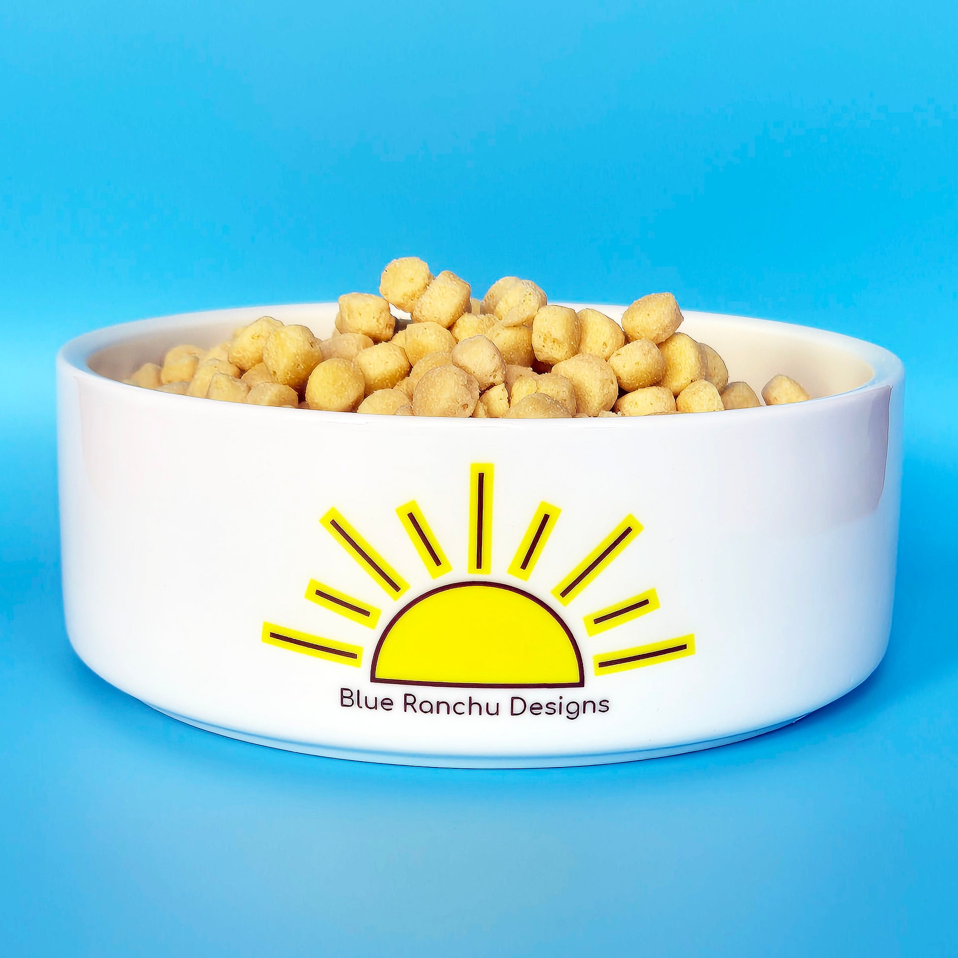 Back of ceramic pet bowl with sunrise design and logo