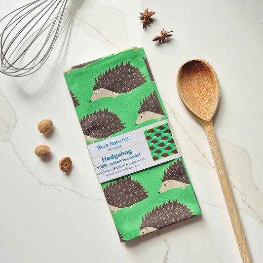 Green tea towel with hedgehog repeating pattern