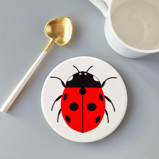 Large white ceramic coaster with a single Ladybird design