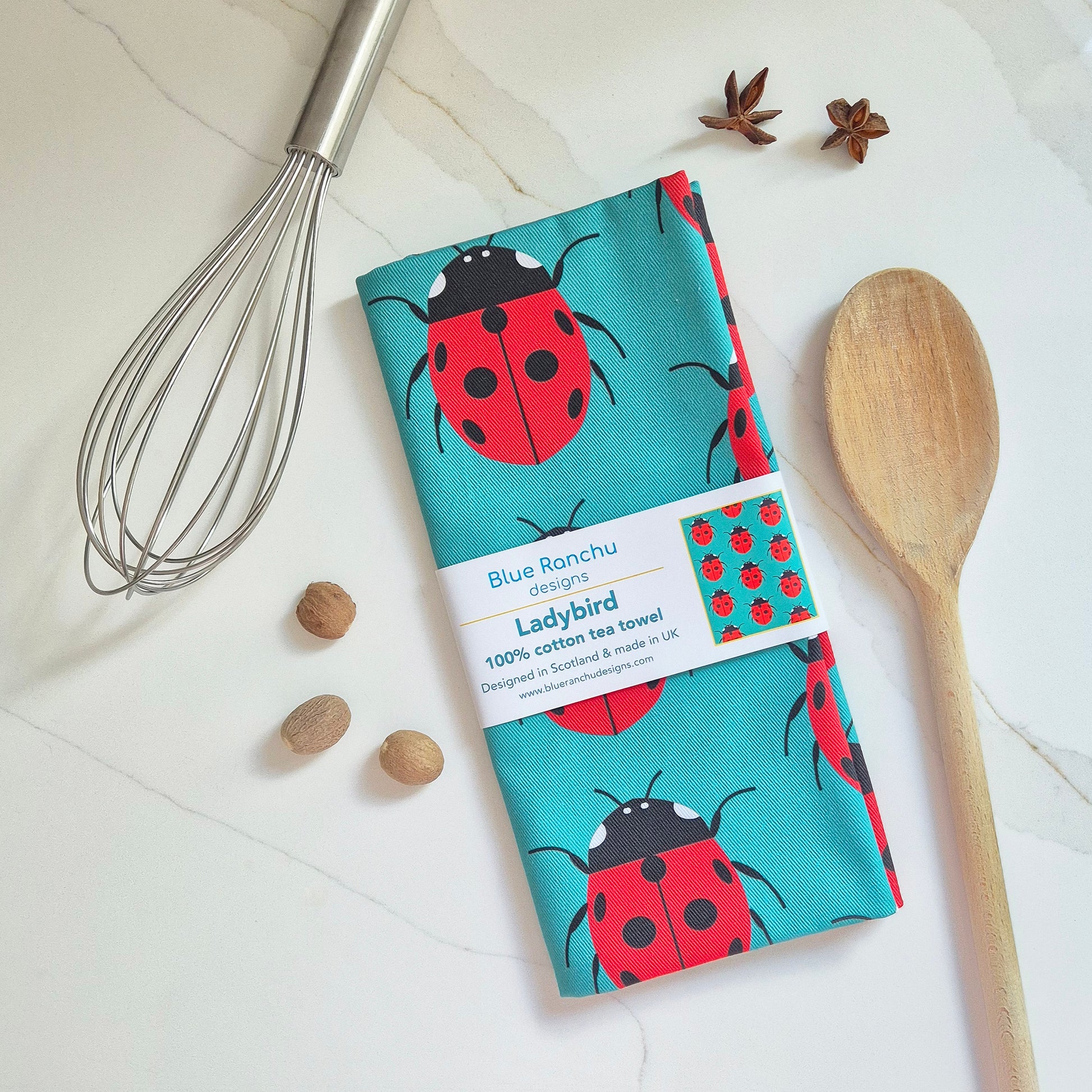 Ladybird cotton tea towel folded on the worktop