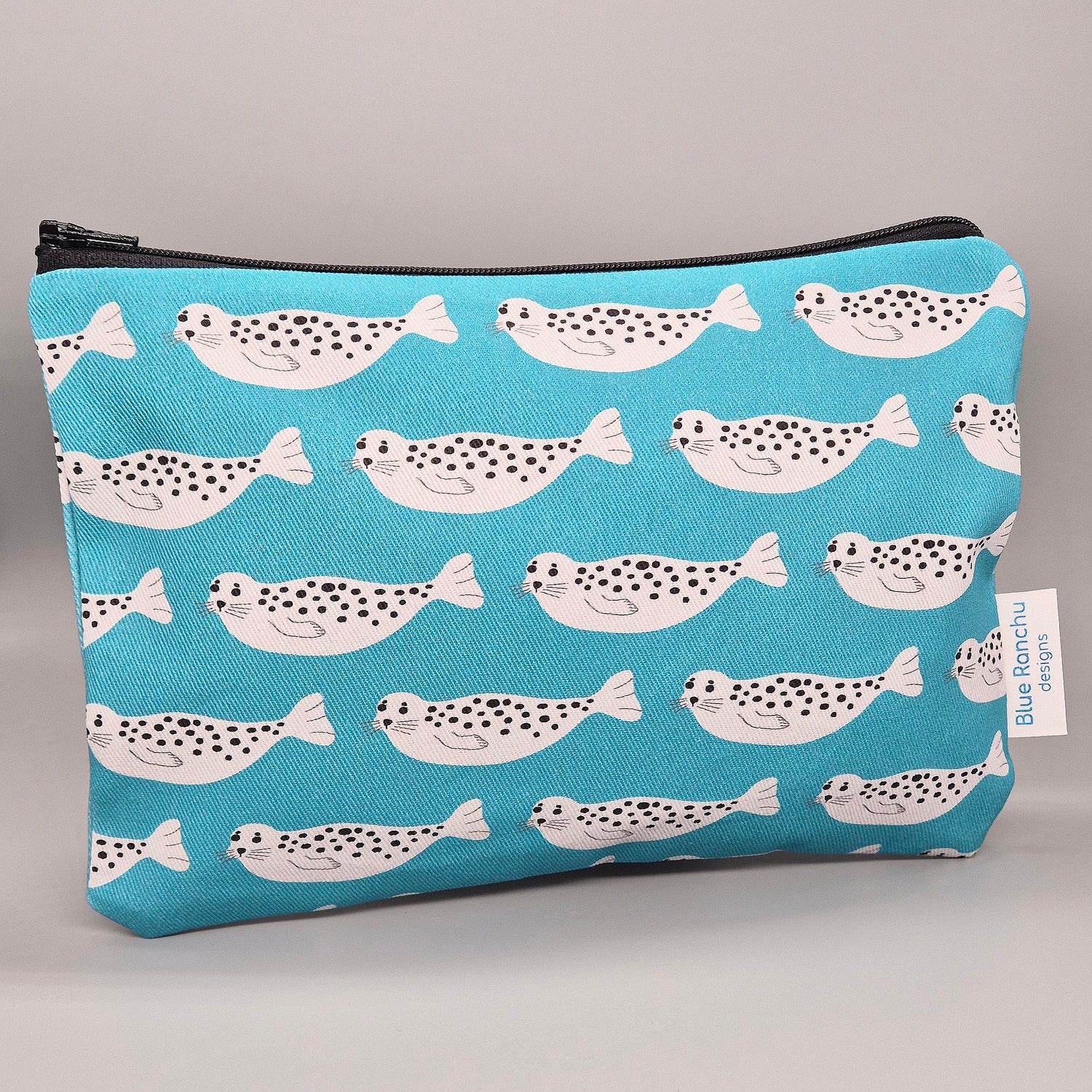 Grey Harbour Seal repeat pattern on a turquoise background handmade accessories bag