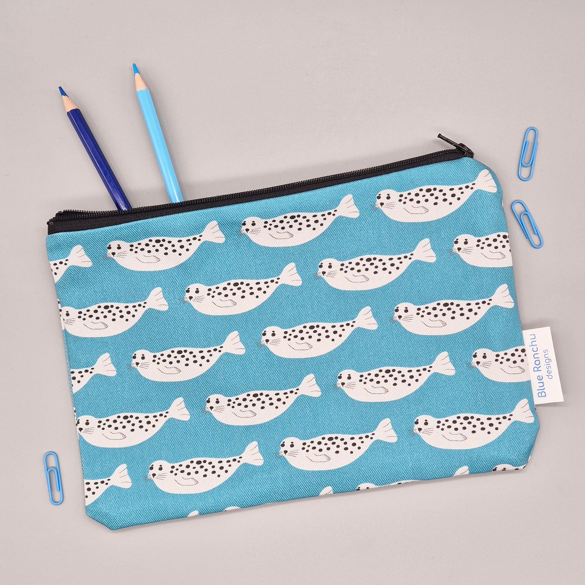 Grey Harbour Seal repeat pattern on a turquoise background handmade pencil case/accessories bag