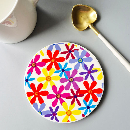 Multicoloured summer flowers printed onto a ceramic coaster