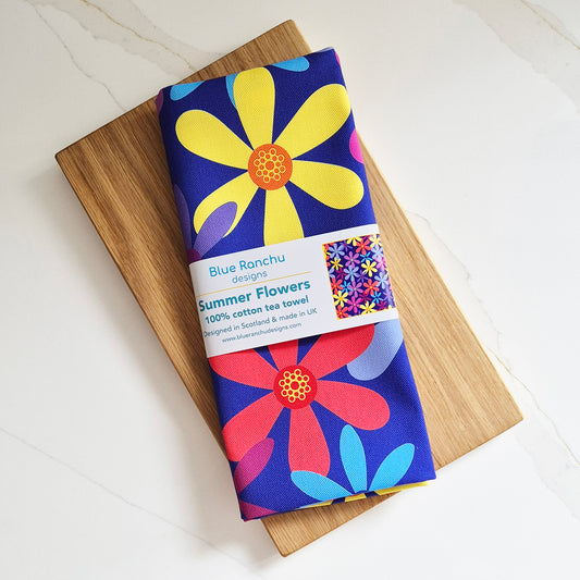 Summer flowers tea towel folded with a belly band