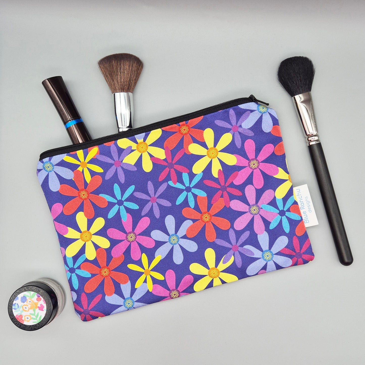 Multicoloured summer flowers make up bag