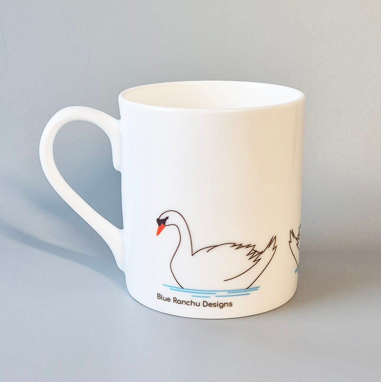 Three swans on a bone china mug